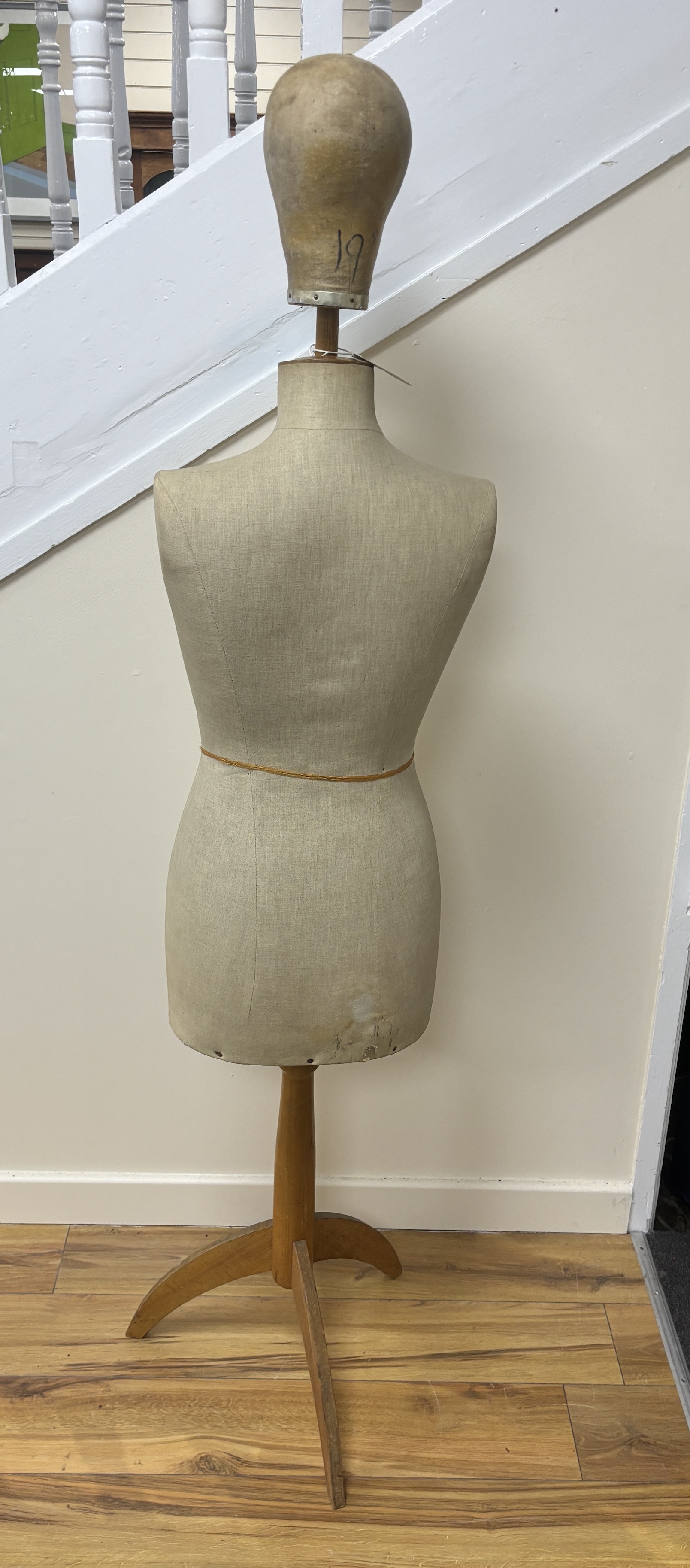 An adult mannequin on a tripod stand, with a separate mannequin head, 142cm from floor to top of torso